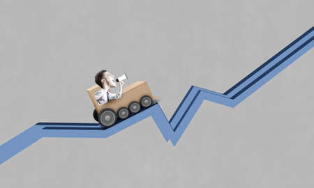 Funny image of businessman riding in carton trainの写真素材