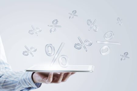 Close up of businessman hand holding tablet and glass symbols