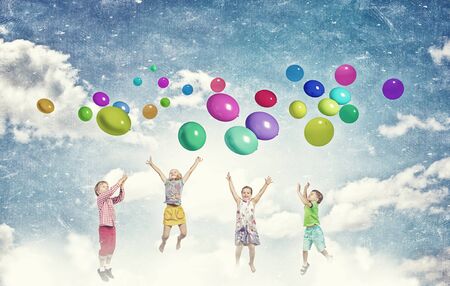 Group of happy children playing with colorful balloonsの写真素材