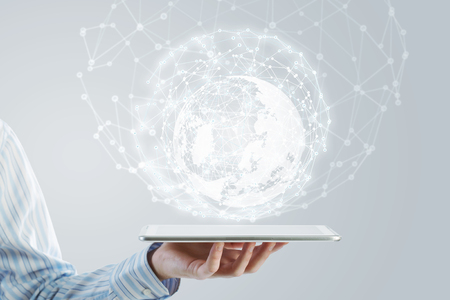 Businessman holding in hand tablet with global connection conceptの写真素材