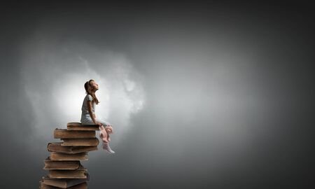 Cute girl wearing pajamas with toy bear in handの写真素材