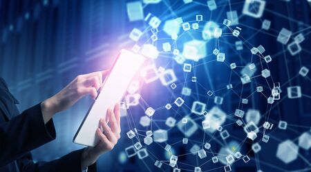 Hands of businesswoman with tablet pc against high tech background