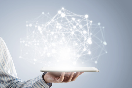 Businessman holding in hand tablet with global connection conceptの写真素材
