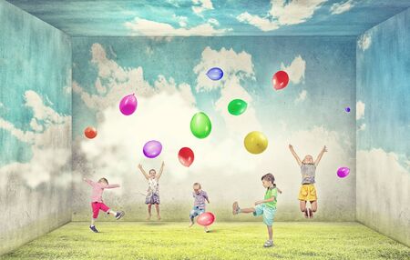 Group of happy children playing with colorful balloonsの写真素材