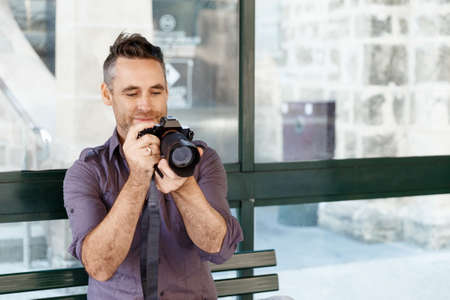 Professional photographer taking picture in cityの写真素材