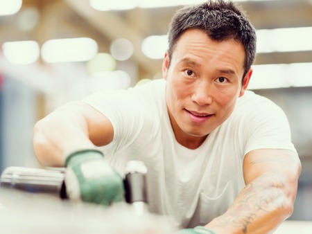 portrait of asian worker in production plant working on the factory floorの写真素材