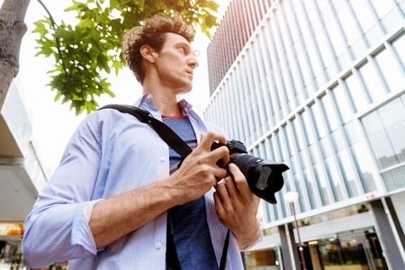Professional photographer taking picture in cityの写真素材