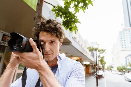 Professional photographer taking picture in cityの写真素材