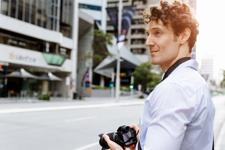 Professional photographer taking picture in cityの写真素材