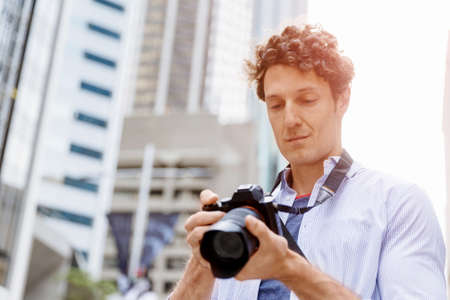 Professional photographer taking picture in cityの写真素材