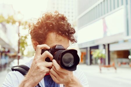 Professional photographer taking picture in cityの写真素材