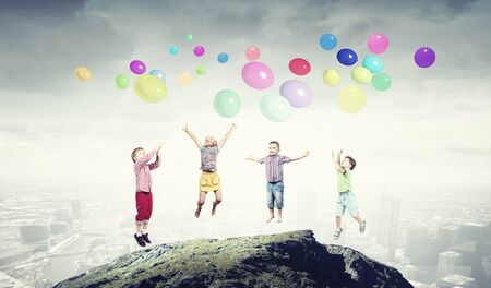 Group of happy children playing with colorful balloonsの写真素材