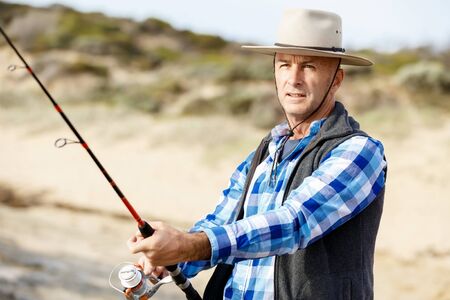 Picture of fisherman fishing with rodsの写真素材