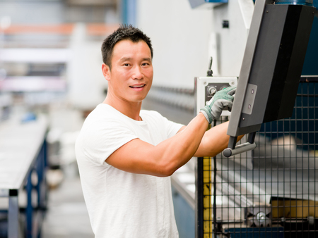 portrait of asian worker in production plant working on the factory floorの写真素材