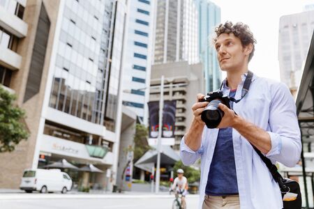 Professional photographer taking picture in cityの写真素材