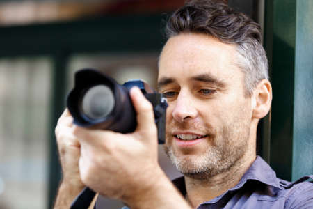 Professional photographer taking picture in city