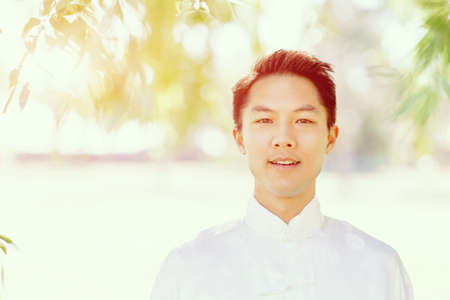 Handsome man practicing thai chi in the park in the summertimeの写真素材