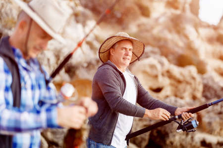 Picture of fishermen fishing with rodsの写真素材