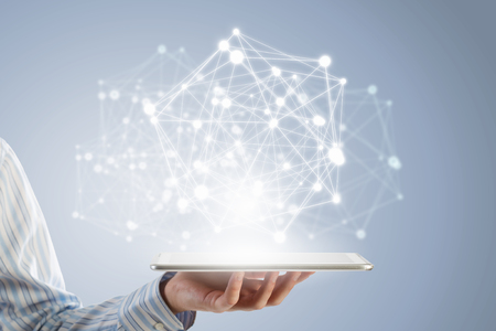 Businessman holding in hand tablet with global connection conceptの写真素材