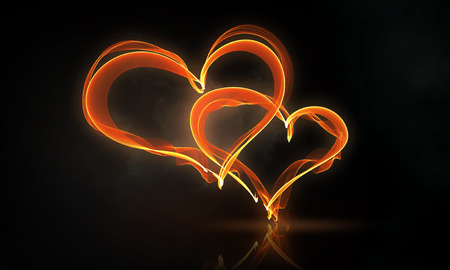 Glowing love hearts symbols on dark backgroundの写真素材