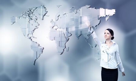 Attractive businesswoman touching with finger virtual interface screenの写真素材