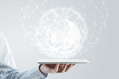 Businessman holding in hand tablet with global connection conceptの写真素材