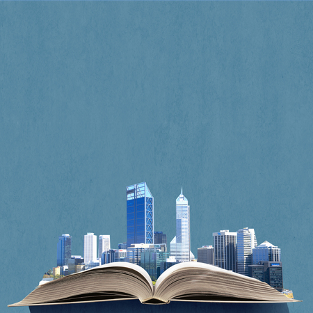 Opened book with modern city model on pagesの写真素材