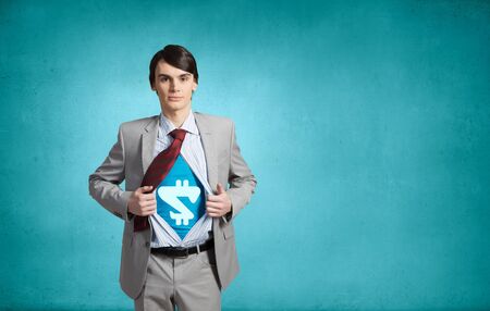 Businessman with dollar sign on chest acting like superheroの写真素材