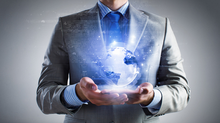 Close up of businessman holding digital globe in palmの写真素材