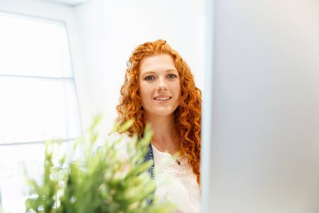 Young and pretty business woman working in office