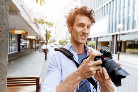 Professional photographer taking picture in cityの写真素材
