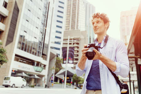 Professional photographer taking picture in cityの写真素材