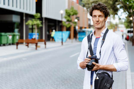 Professional photographer taking picture in cityの写真素材