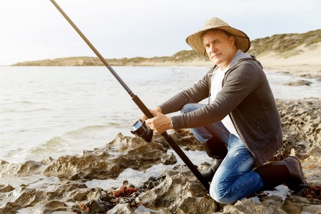 Picture of fisherman fishing with rodsの写真素材