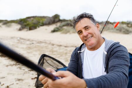 Picture of fisherman fishing with rodsの写真素材