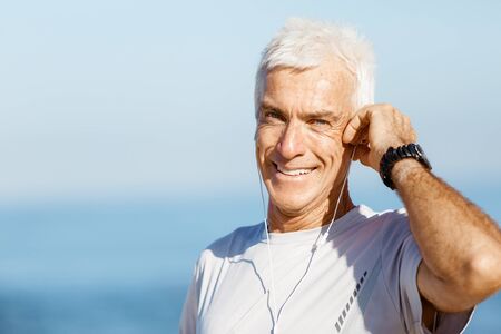 Sports and music. man getting ready for jogging and listening to the MP3 playerの写真素材