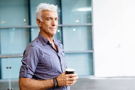 Handsome businessman in casual wear working in officeの写真素材
