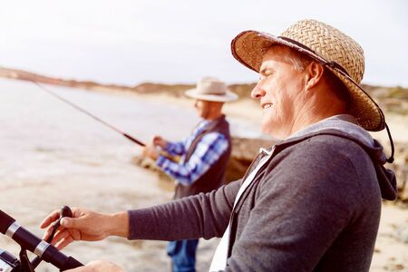Picture of fishermen fishing with rodsの写真素材