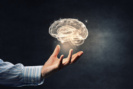 Close up of human hand holding brain symbiolの写真素材