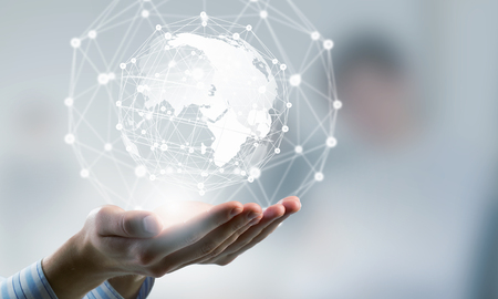 Global connection concept with digital planet in handsの写真素材