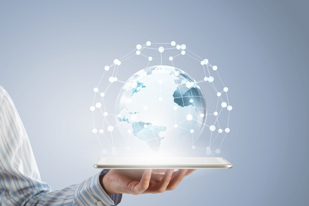 Businessman holding in hand tablet with global connection conceptの写真素材