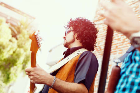 A street musician playing his guitarの写真素材