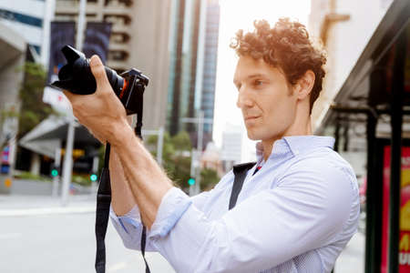 Professional photographer taking picture in city
