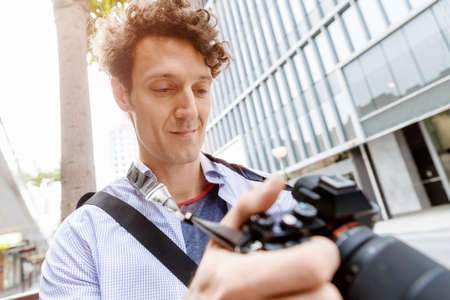 Professional photographer taking picture in cityの写真素材