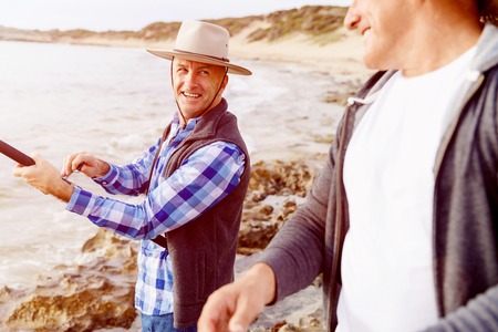 Picture of fishermen fishing with rodsの写真素材