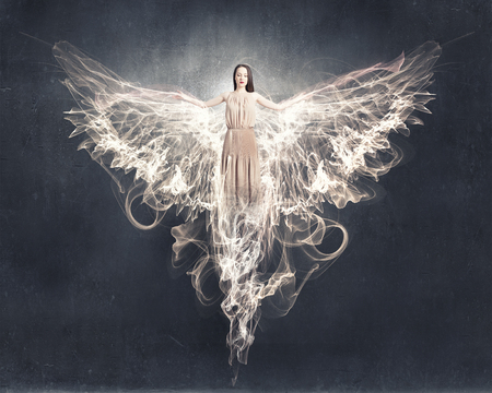 Attractive woman with angel wings on sky backgroundの写真素材