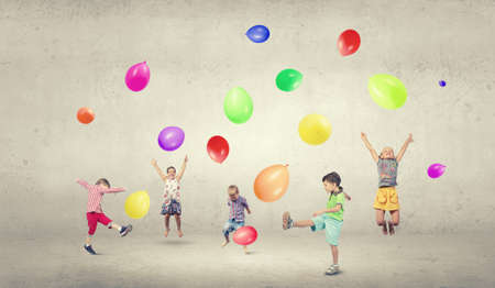 Group of happy children playing with colorful balloonsの写真素材
