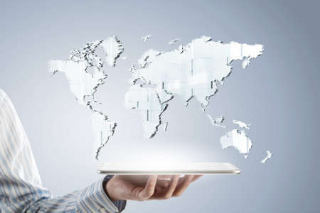 Businessman hands holding tablet with world map on screen