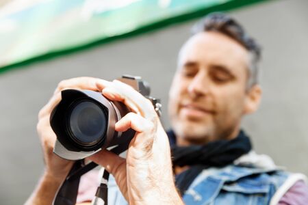 Professional photographer taking picture in cityの写真素材