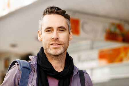 Happy male tourist in casual clothes in city walkingの写真素材